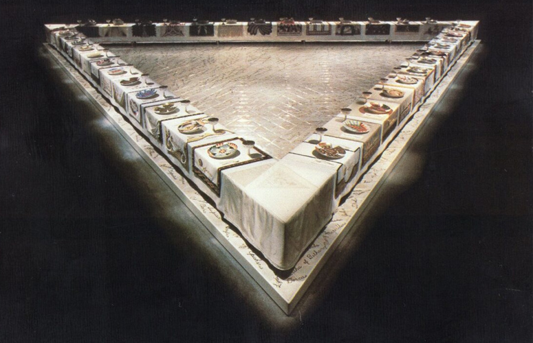 Picture postcard of an image showing the complete art installation entitledâ€¯The Dinner Partyâ€¯by artist Judy Chicago.